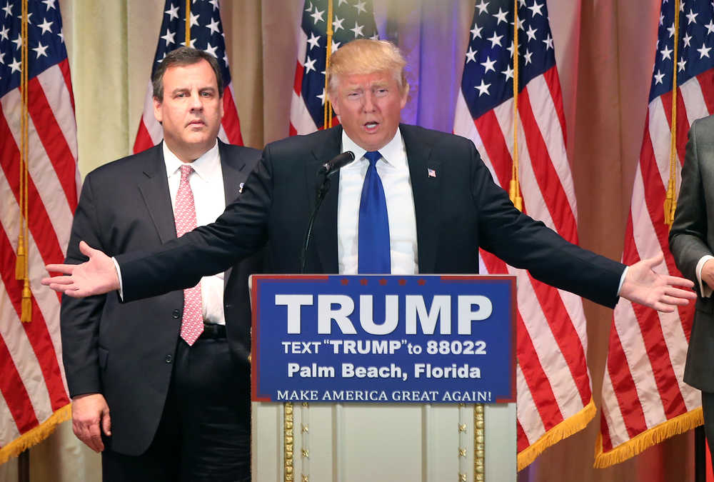 Republican presidential candidate Donald Trump speaks on Super Tuesday primary election night at the White and Gold Ballroom at The Mar-A-Lago Club in Palm Beach, Fla., Tuesday, March 1, 2016. New Jersey Gov. Chris Christie listens in the background. (AP Photo/Andrew Harnik)