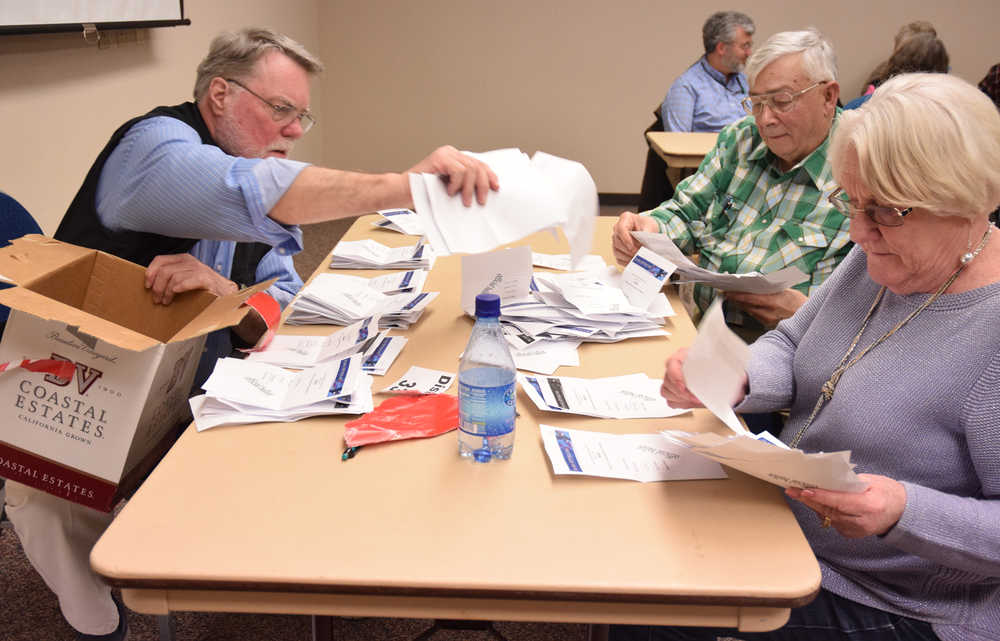 Volunteers tally votes after the close of the Republican Presidential Preference Poll on March 1, 2016 in Centennial Hall's Egan Ballroom.