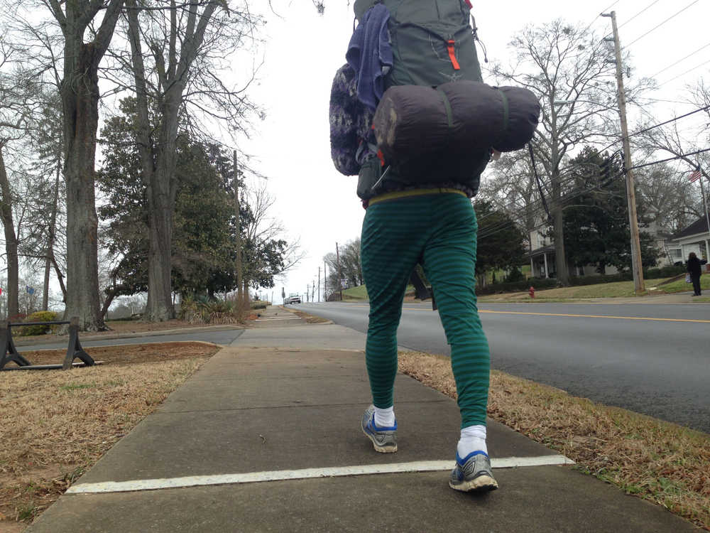 Nick Rutecki and Logan Miller are walking around America - consciously choosing to walk along roads as opposed to trails, in large part because of all the people they meet. Here, Nick Rutecki walks along a sidewalk in the South.