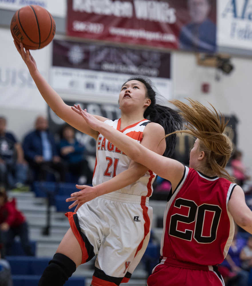 Yakutat's Dani Go lays the ball up against Klawock's Ashley Huffine during the 1A Region V Basketball Championship game at Thunder Mountain High School on Friday. Klawock won 37-35.