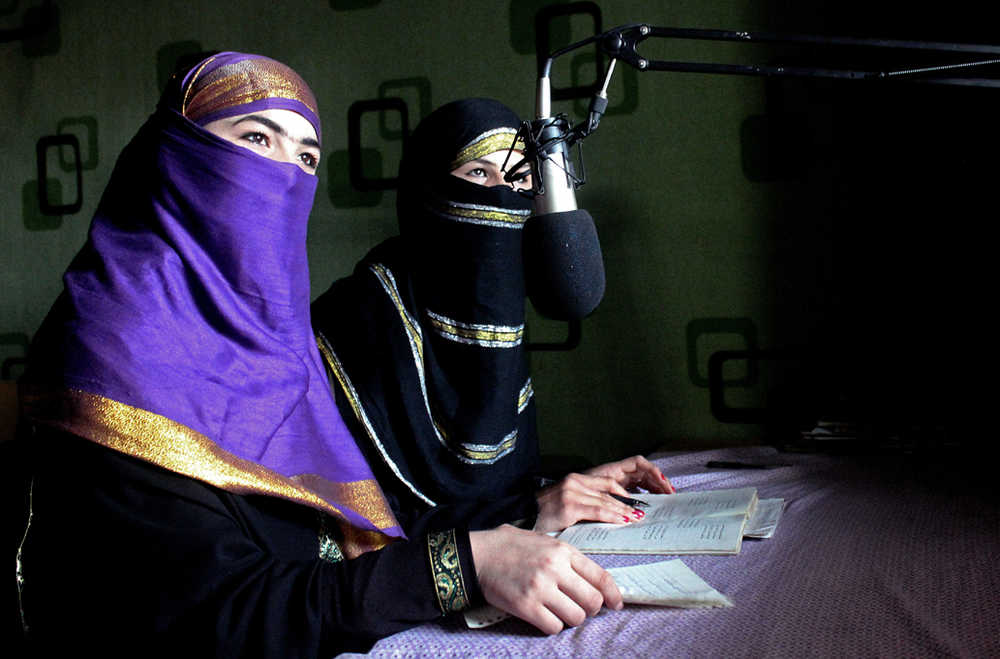 In this Friday photo, broadcasters of Radio Shaesta prepare themselves to go on-air, in Kunduz, Afghanistan.