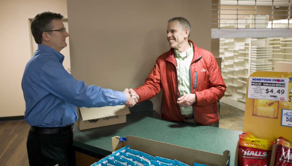 Tyler Myers, president of the Myers Group and owner of IGA Foodland, left, greets Scott Watts, owner of Ron's Apothecary Shoppe, at IGA Foodland on Wednesday. The new pharmacy will open later this month.