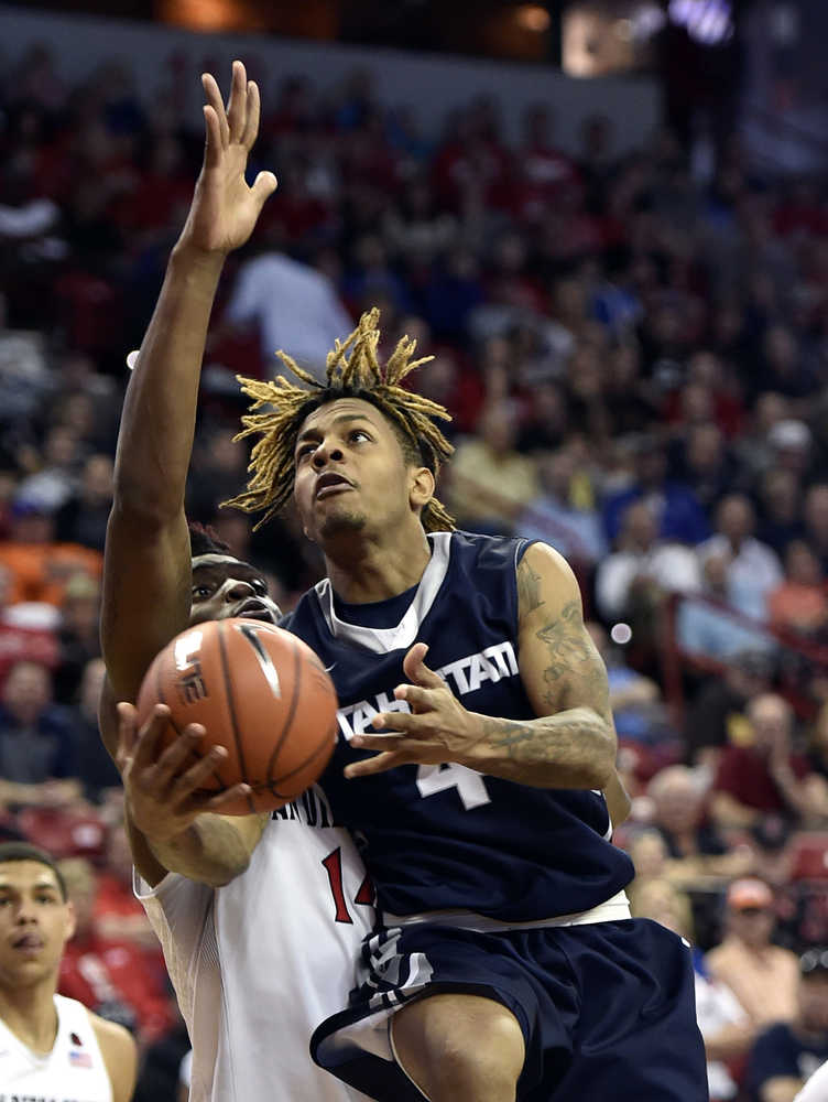 Utah State's Shane Rector shoots against San Diego State during the second half of an NCAA Mountain West Conference men's tournament game on Thursday in Las Vegas. San Diego State won 71-65.