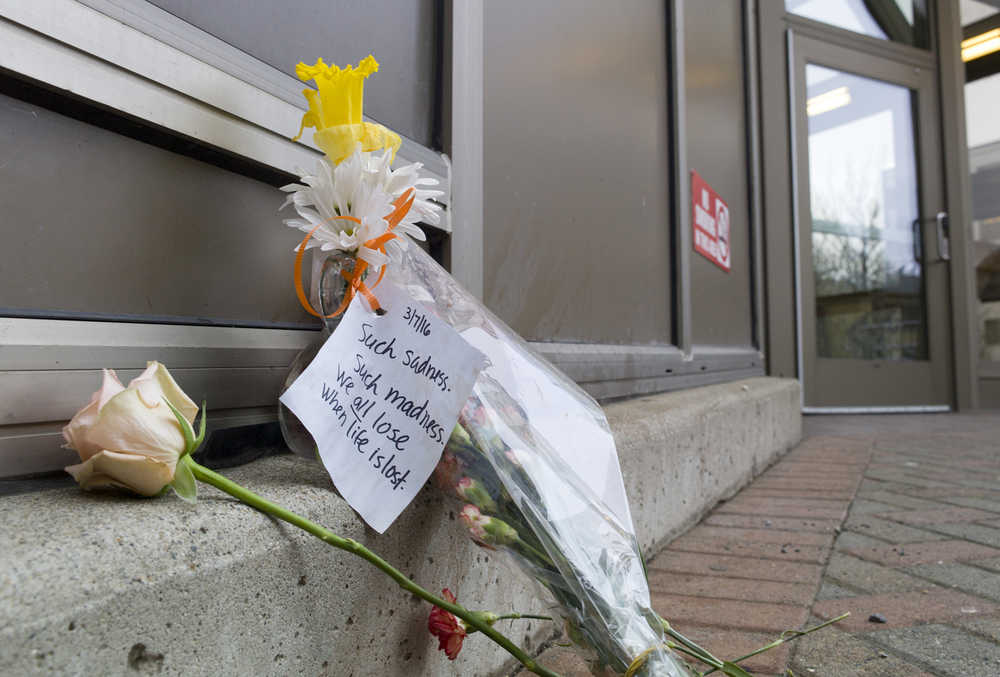 Flowers and a note are left outside the main entrance to the Dimond Courthouse on Tuesday. Miranda Ellen Davison, 34, shot and killed herself at the location on Monday.