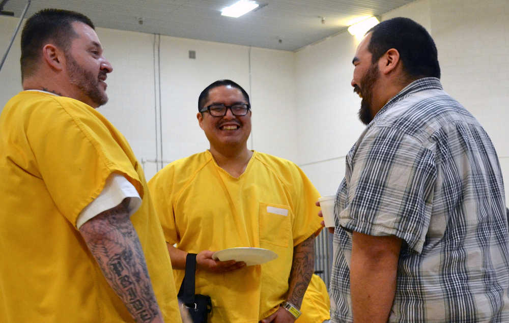 Former LCCC inmate Brandon Johnson, right, speaks with two inmates during a break at the ninth annual Success Inside and Out conference in the prison. During the event, Johnson spoke as a panelist, offering advice to his former peers.