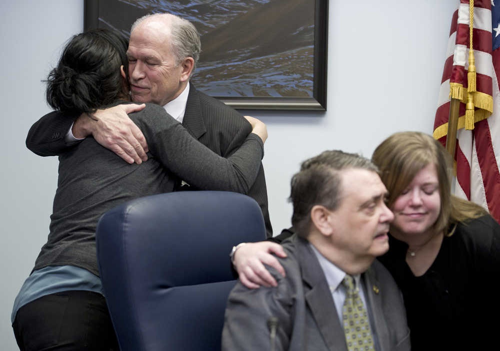 Gov. Bill Walker, left, hugs Kara Nelson, director of Haven House, as Rep Geran Tarr, D-Anchorage, right, contratulates Sen. Johnny Ellis, D-Anchorage, after the Governor signed Senate Bill 23 at the Capitol on Monday. The bill gives public access to the life-saving heroin antidote called Naxolone.