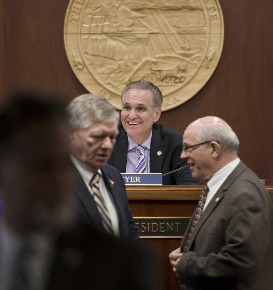 Senate President Kevin Meyer, R-Anchorage, shares a light moment with other senators during debate of the state's operating budget at the Capitol on Monday.