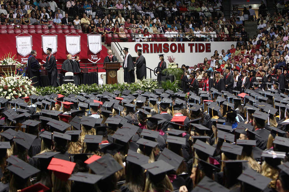 In this Aug. 6, 2011 photo, University of Alabama students receive their diplomas at Coleman Coliseum in Tuscaloosa, Alabama. While 58 percent of black male undergraduates at the 65 schools in the Power 5 conferences got degrees within six years, 54 percent of black male student-athletes at the same schools graduated, according to an analysis of the 2014-2015 academic year by University of Pennsylvania researcher Shaun Harper.