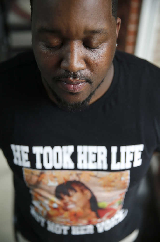 In this March 4 photo, Martinez Sutton wears a shirt commemorating his sister, Rekia Boyd, 22, who was shot and killed in 2012 by a Chicago police officer. Sutton has been pushing for the firing of officer Dante Servin, who, while off-duty, was driving in an alley when he argued with a group of people. Servin fired several shots over his shoulder, striking a Boyd with a fatal head wound.
