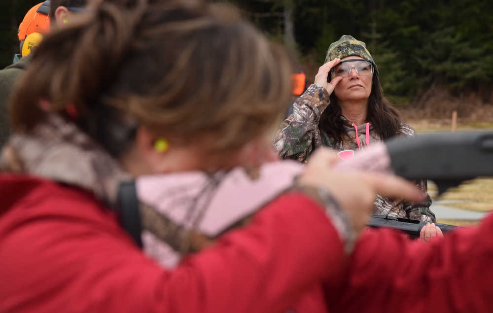 Rep. Charisse Millett, R-Anchorage, watches from afar as her teammate, Rep. Lynn Gattis, R-Wasilla, prepares to shoot a clay pigeon during the shotgun challenge portion of the 2016 Legislative Shoot, hosted by the Alaska Correctional Officers Association on Saturday at the Juneau Gun Club, Juneau Archery Club and the hunter training center on Montana Creek Road.