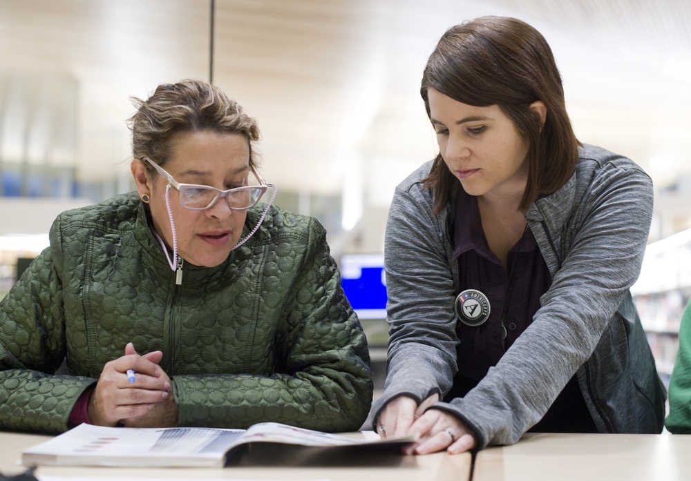 Delia Canales, left, originally from Mexico, receives instruction from Felicite Toney during an English as a Second Language class at the Mendenhall Valley Public Library last month. The Learning Connection provides ESL and immigration courses for free.