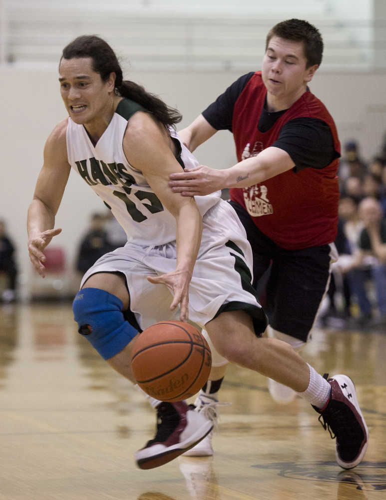 Haines' Ryan Harms is grabbed by Hydaburg's Tyrell Edenshaw during their "B" bracket game in the 2016 Juneau Lions Club 70th Gold Medal Basketball Tournament at Juneau-Douglas High School on Monday.