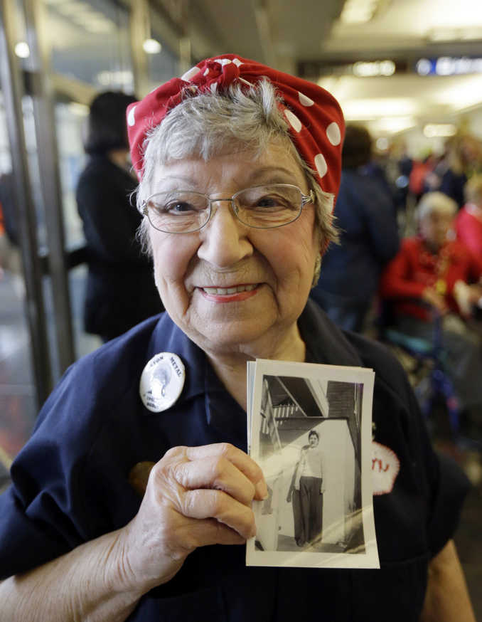 Former Rosie, T. Ogden of Aurora, Illinois, shows a photo of herself after greeting fellow Rosies from Michigan on their arrival in Washington on Tuesday.