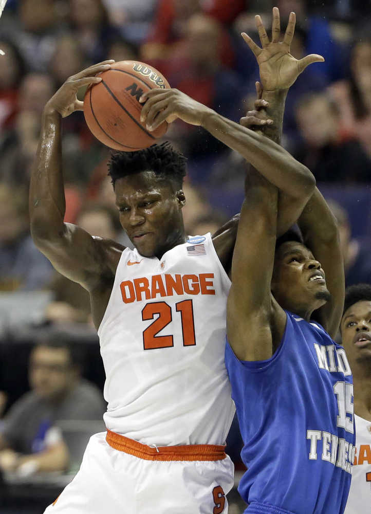 In this March 20 photo, Syracuse's Tyler Roberson, left, and Middle Tennessee's Aldonis Foote reach for a rebound during a second-round game in the NCAA Tournament, in St. Louis.