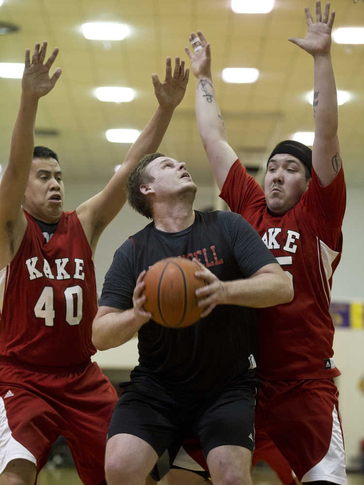 Wrangell's Graham Gablehouse, center, looks for the basket against Kake's Shawn Jackson, left, and Dion Jackson during their B bracket game in the 2016 Juneau Lions Club 70th Gold Medal Basketball Tournament at Juneau-Douglas High School on Wednesday.