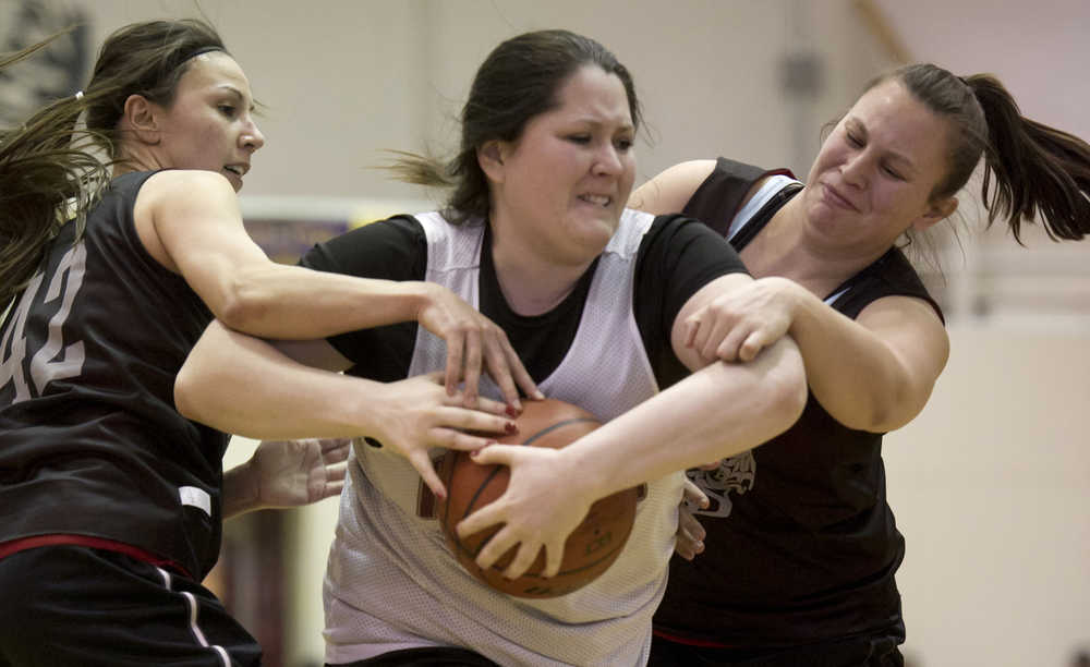 Haines' Tiffany DeWitt, center, tries to fend off Craig's Jessica Lingley, left, and Sarah Dybdahl during their Womens bracket game in the 2016 Juneau Lions Club 70th Gold Medal Basketball Tournament at Juneau-Douglas High School on Thursday. Craig won 59-45.