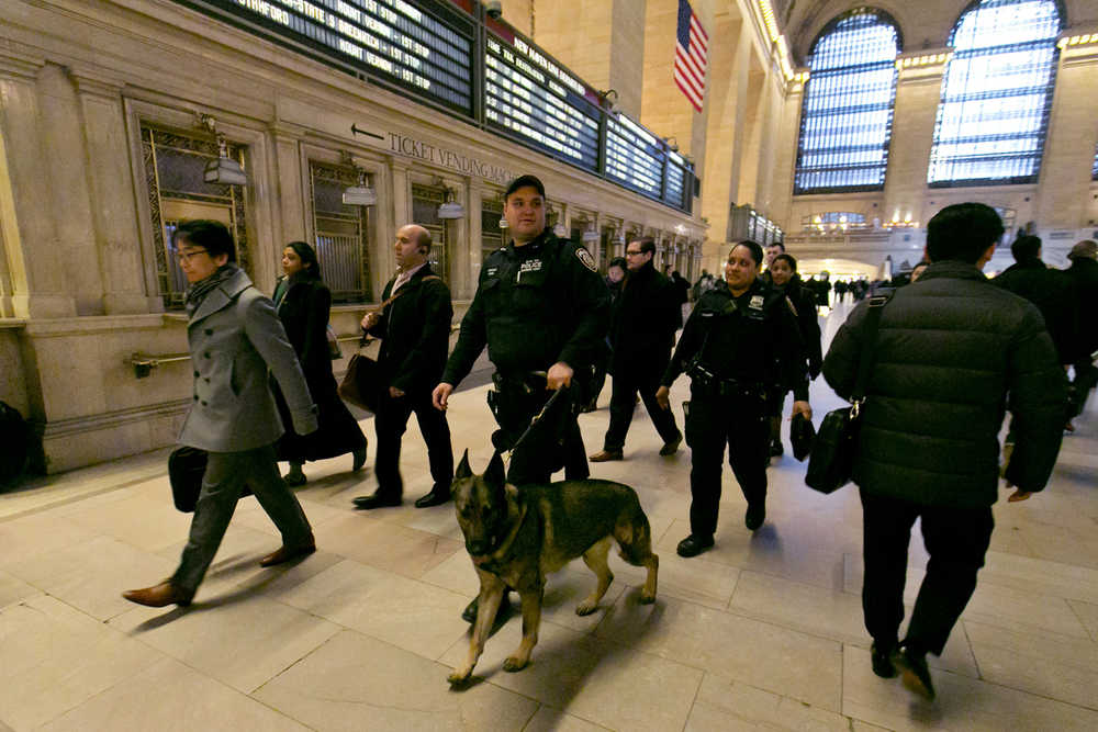 In this March 22 photo, Metro-North Railroad police officers with a police dog patrol Grand Central Terminal, in New York.