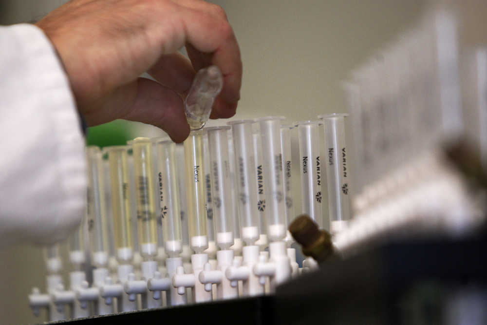 In this Feb. 5, 2010 photo, a laboratory technician prepares samples of urine for doping tests during a media open day, at the King's College London Drug Control Centre in London.