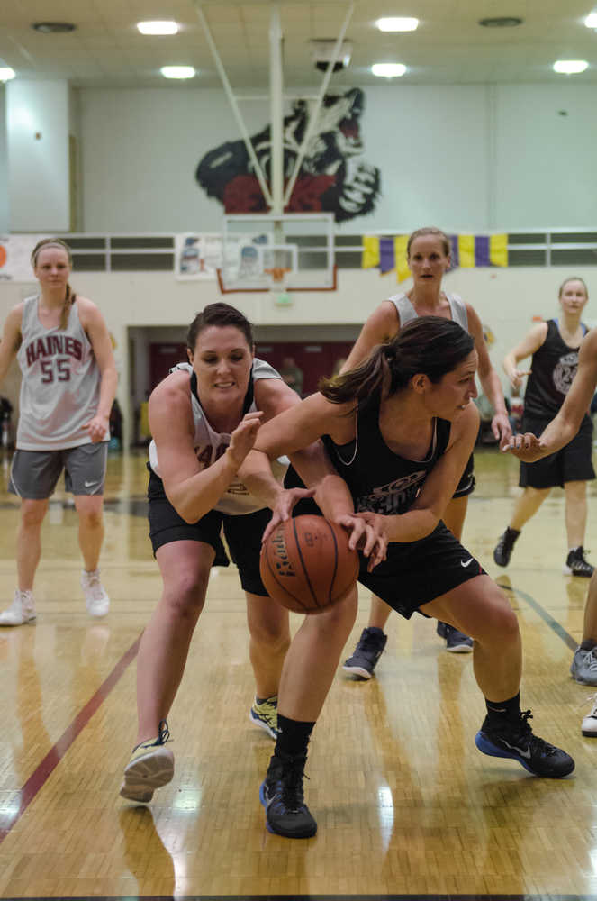Haine's Jamie Stanford attempts to steal the ball away from Craig's Tina Steffen during their 70th annual Gold Medal Basketball Tournament championship game Saturday at Juneau-Douglas High School. Haines won 54-49.
