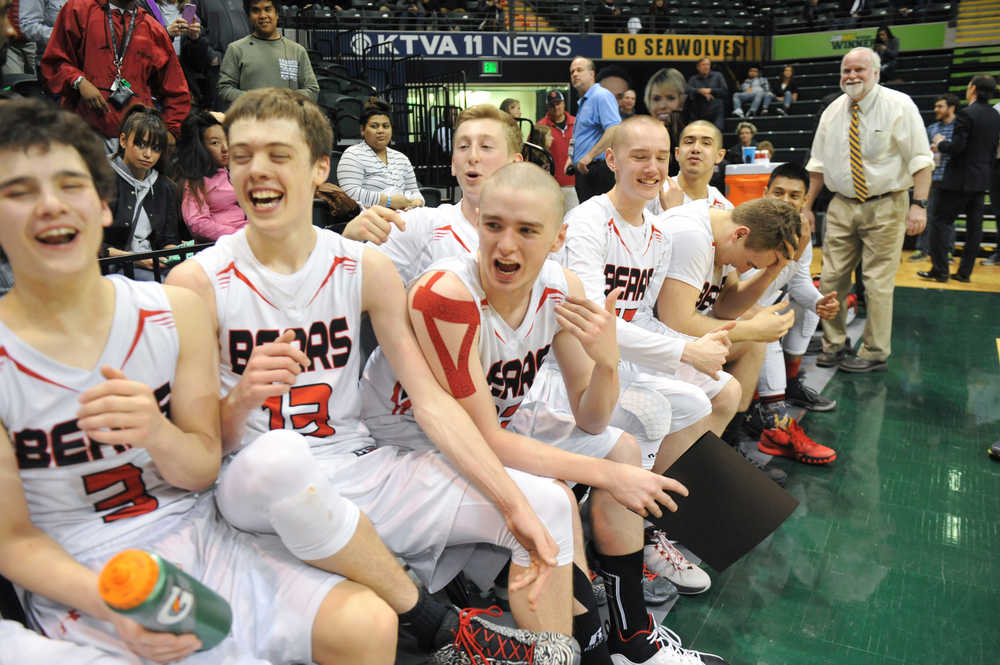 Player of the Game Guy Bean, center, shares a laugh with fellow starters Treyson Ramos, far left, and Kaleb Tompkins, left, during their ASAA March Madness Alaska 4A championship win on Saturday in Anchorage.
