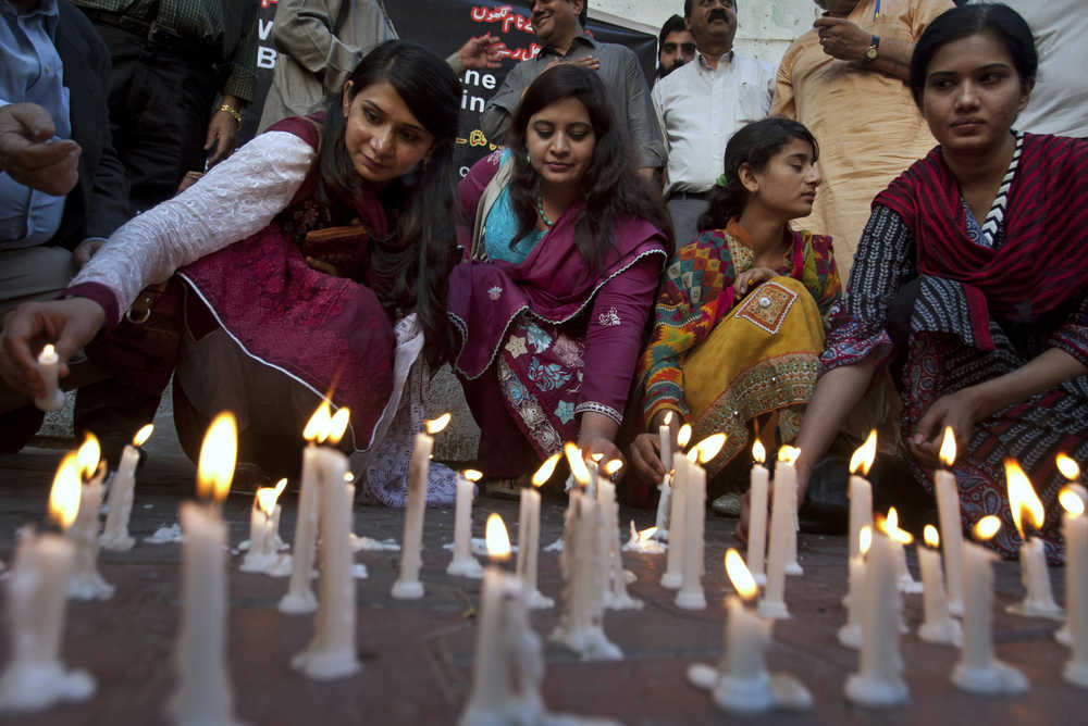 Members of a civil society group light candles during a vigil for the victims of Sunday's suicide bombing, Monday, March 28, 2016 in Karachi, Pakistan. Pakistan's prime minister vowed to eliminate perpetrators of terror attacks such as the massive suicide bombing that targeted Christians gathered for Easter the previous day in the eastern city of Lahore, killing tens of people. (AP Photo/Shakil Adil)