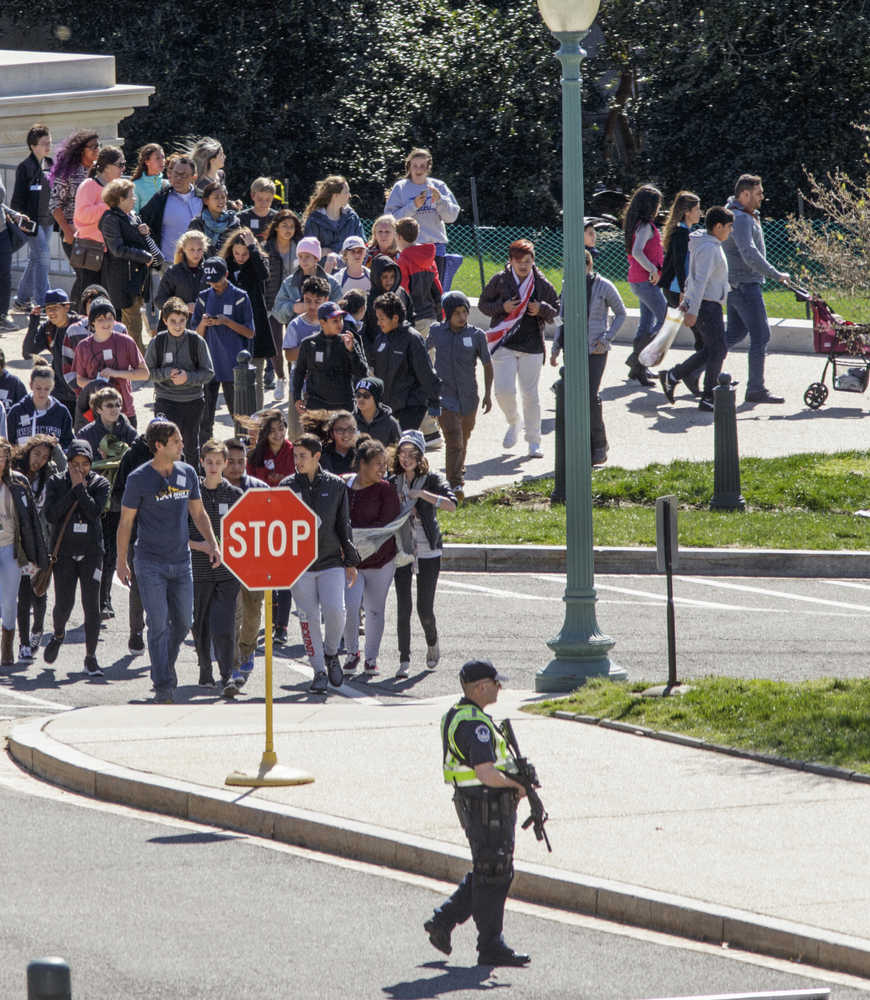 Tourists are directed by Capitol Police away from the Capitol at Constitution Ave. and Delaware Ave. in Washington, Monday, March 28, 2016. A gunman was taken into custody after firing shots in the U.S. Capitol complex on Monday, Capitol officials said, and visitors and staff were shut in their offices and told to "shelter in place."   (AP Photo/J. Scott Applewhite)