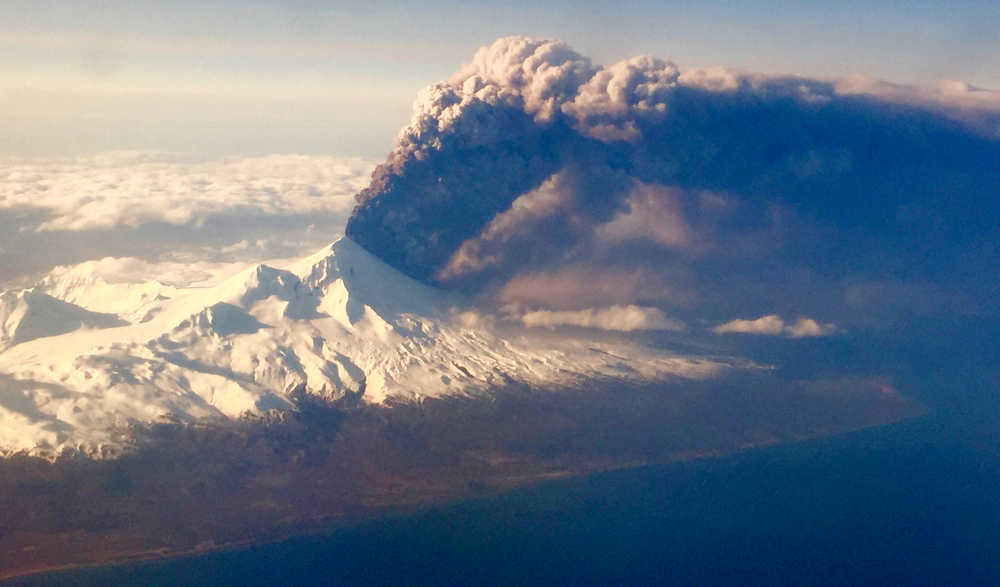 In this Sunday, March 27, 2016, Pavlof Volcano, one of Alaska's most active volcanoes, erupts, sending a plume of volcanic ash into the air. The Alaska Volcano Observatory says activity continued Monday. Pavlof Volcano is 625 miles southwest of Anchorage on the Alaska Peninsula, the finger of land that sticks out from mainland Alaska toward the Aleutian Islands. (Colt Snapp via AP) MANDATORY CREDIT