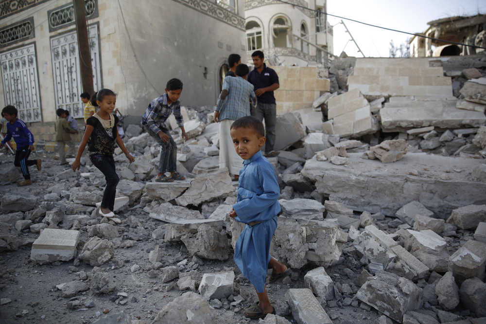 FILE -- In this Sept. 8, 2015 file photo, children play amid the rubble of a house destroyed by a Saudi-led airstrike in Sanaa, Yemen. Hunger has been the most horrific consequence of Yemen's conflict and has spiraled since Saudi Arabia and its allies, backed by the U.S., launched a campaign of airstrikes and a naval blockade a year ago. (AP Photo/Hani Mohammed, File)