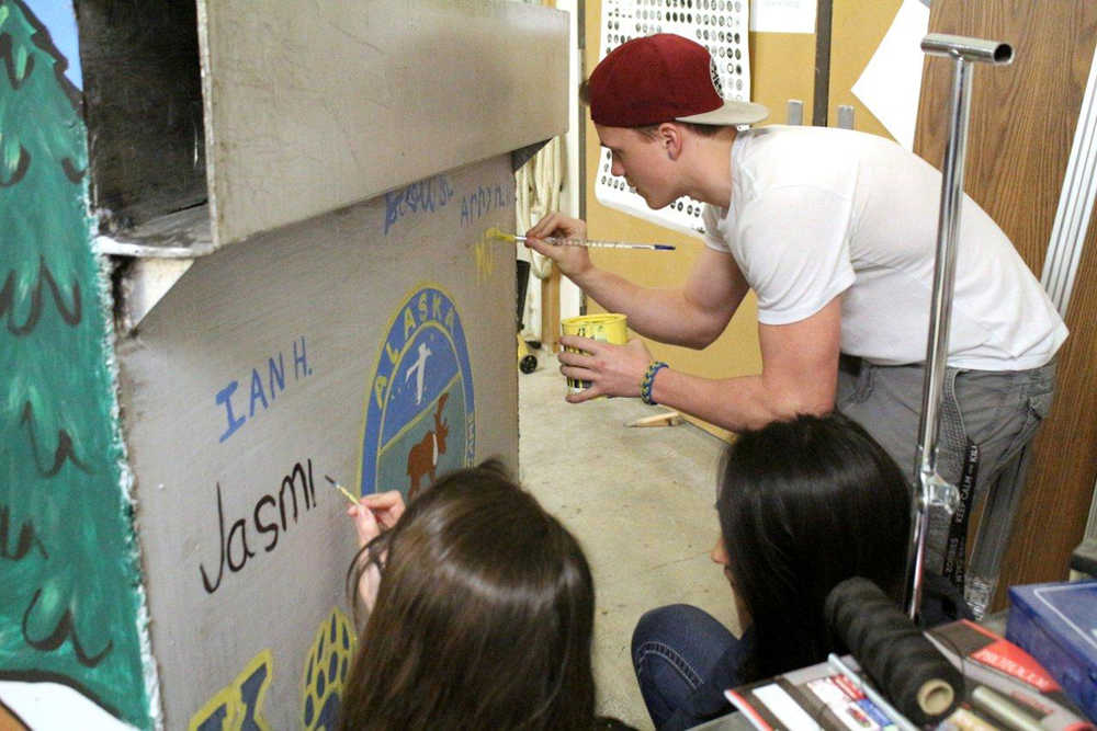 In this March 29, 2016 photo, high school students decorate trash bins that will are being modified to be more bear-resistant in Kodiak, Alaska. The Kodiak Daily Mirror reports that the project is a joint effort by the Kodiak Brown Bear Trust, Alaska Waste and Kodiak High School. (Julie Herrmann/Kodiak Daily Mirror via AP)