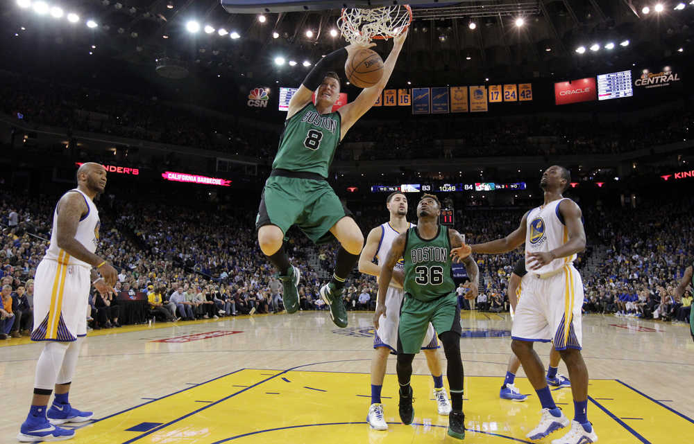 Boston Celtics' Jonas Jerebko (8) dunks against the Golden State Warriors during the second half of an NBA basketball game Friday in Oakland, California. Boston won 109-106.