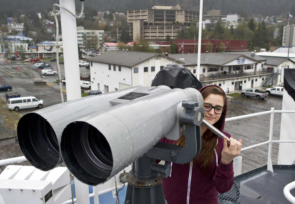 Kyleigh Hurt takes in the view of Juneau's downtown harbor with the help of the high-power binoculars aboard the U.S. Coast Guard Cutter Morgenthau during a public tour on Monday. The Morgenthau, a 378-foot Hamilton-class high endurance cutter homeported in Honolulu, Hawaii, has a crew of 160, including 20 officers and 140 enlisted personnel. The crew patrols from South America to the Bering Sea, conducting counter-narcotics missions, alien migrant interdiction operations, foreign and domestic fisheries enforcement, and search and rescue.