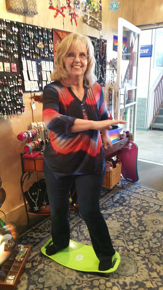 Sherry Denny, the manager at Northern Glitter Boutique, demonstrates the latest craze in exercise -- the Simply Fit Board.