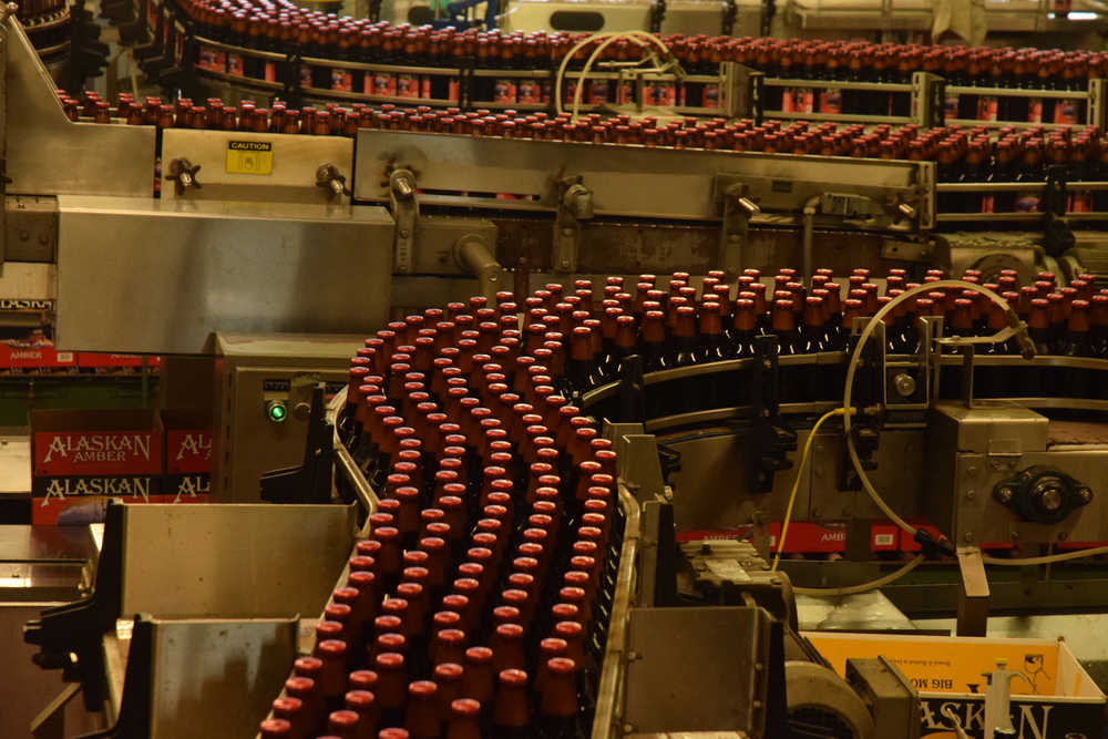 In this July 7, 2015, photo, bottles of Alaskan Amber beer roll along the bottling line at the Alaskan Brewing Company.