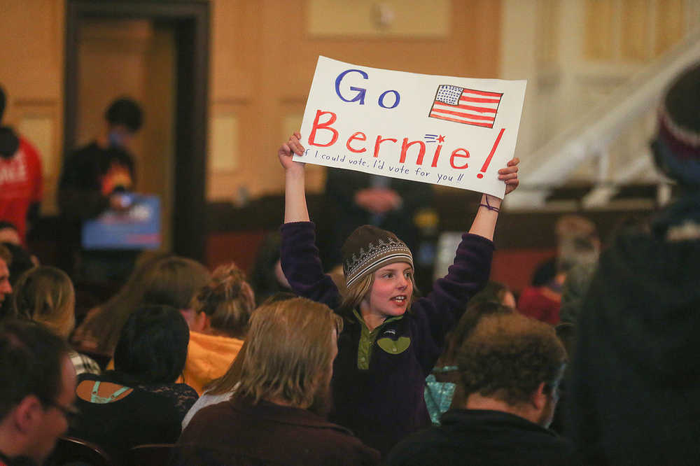 Marlow Mittelstaedt, of Laramie, holds a sign supporting Democratic presidential candidate Sen. Bernie Sanders, I-Vt., during a campaign rally Tuesday evening in the Arts and Sciences Auditorium at the University of Wyoming campus on April 5, 2016, in Laramie, Wyo. (Blaine McCartney/The Wyoming Tribune Eagle via AP) MANDATORY CREDIT