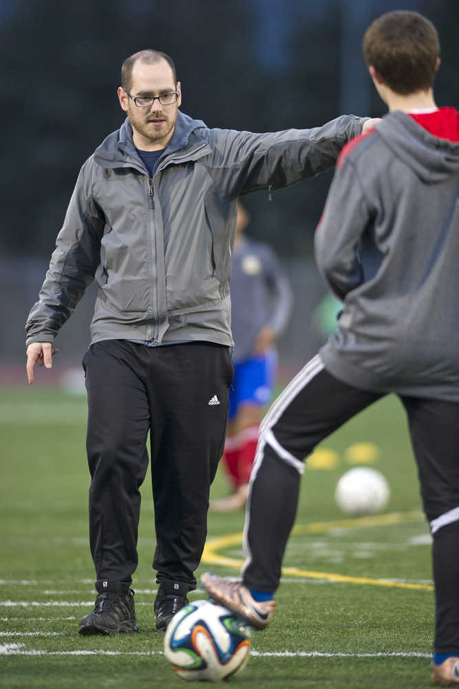 Thunder Mountain High School boys soccer coach Tim Lewis leads his players through a team practice Wednesday at TMHS.