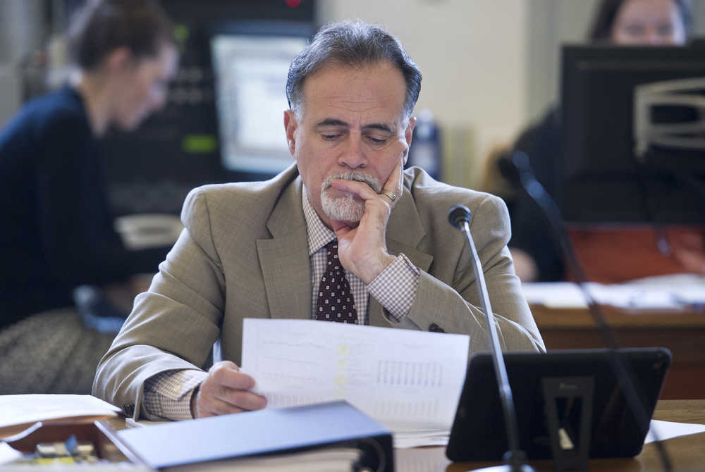 Sen. Peter Micciche, R-Soldotna, studies a chart during the introduction of a new Permanent Fund Dividend bill in the Senate Finance Committee Tuesday that aims to reduce Alaska's budget deficit.