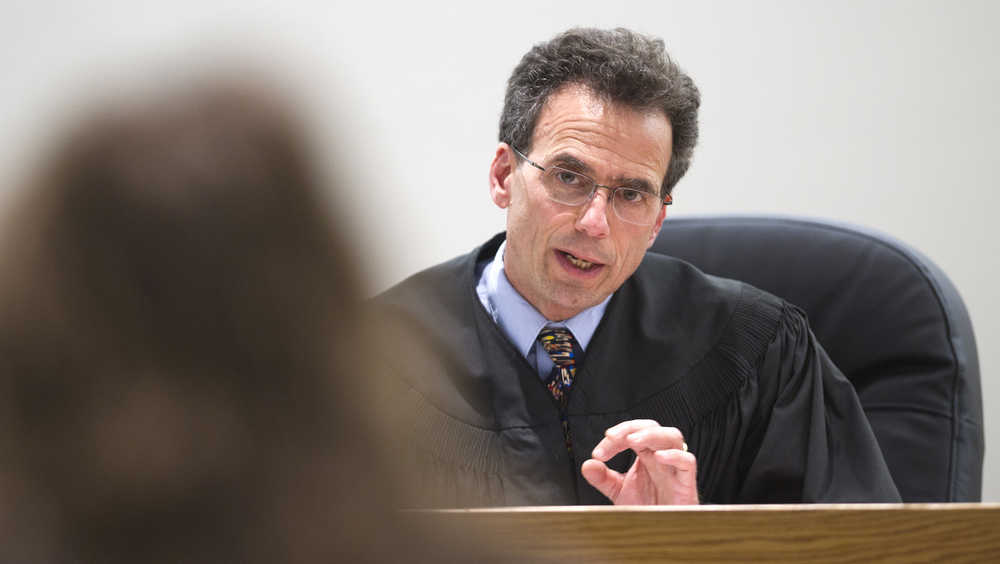 Juneau District Court Judge Keith Levy speaks to a Juneau resident during an arraignment hearing on Wednesday. Judge Levy is retiring.