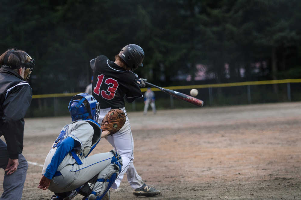 Juneau-Douglas High School's Michael Cesar connects with the pitch during their game against Petersburg on Monday night at Adair Kennedy Park. Juneau won 14-4.
