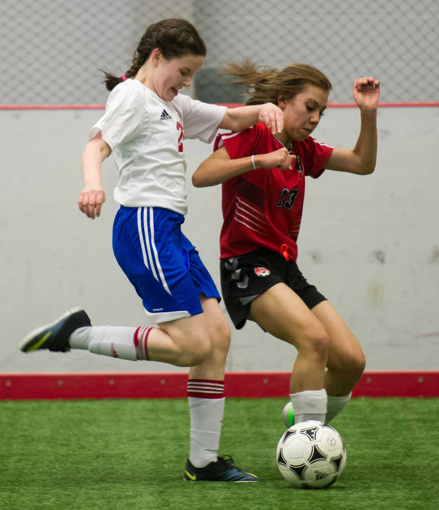Juneau Soccer Club's Jasmin Holst, left, plays against her Whitehorse Soccer Club opponent during a weekend exchange tournament April 15-17, 2016, at the Canada Games Centre in Whitehorse, Yukon.