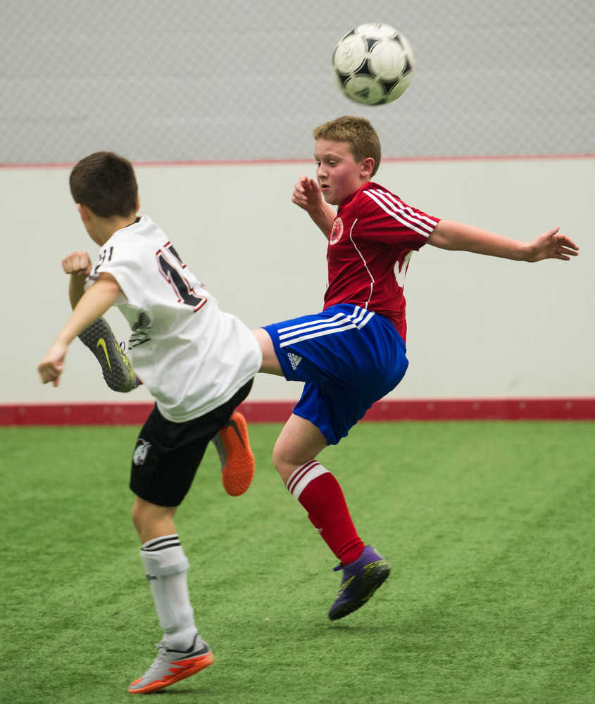 Juneau Soccer Club's Gavin Millard, right, competes for the ball against his Whitehorse Soccer Club opponent during a weekend exchange tournament April 15-17, 2016, at the Canada Games Centre in Whitehorse, Yukon.