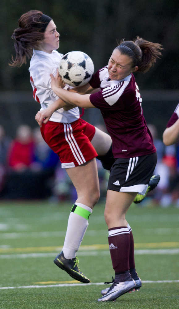 Juneau-Douglas' Rylee Landen, left, collides with Ketchikan's Tia Simpson during their varsity game at Adair-Kennedy Memorial Park on Friday.