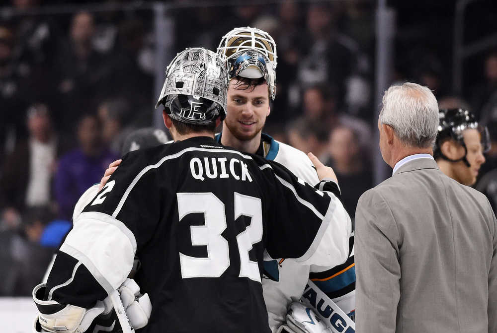 Los Angeles Kings goalie Jonathan Quick, left, and San Jose Sharks goalie Martin Jones, center, greet one another as Kings coach Darryl Sutter watches after Game 5 in an NHL hockey Stanley Cup playoffs first-round series, Friday, April 22, 2016, in Los Angeles. The Sharks won 6-3. (AP Photo/Mark J. Terrill)