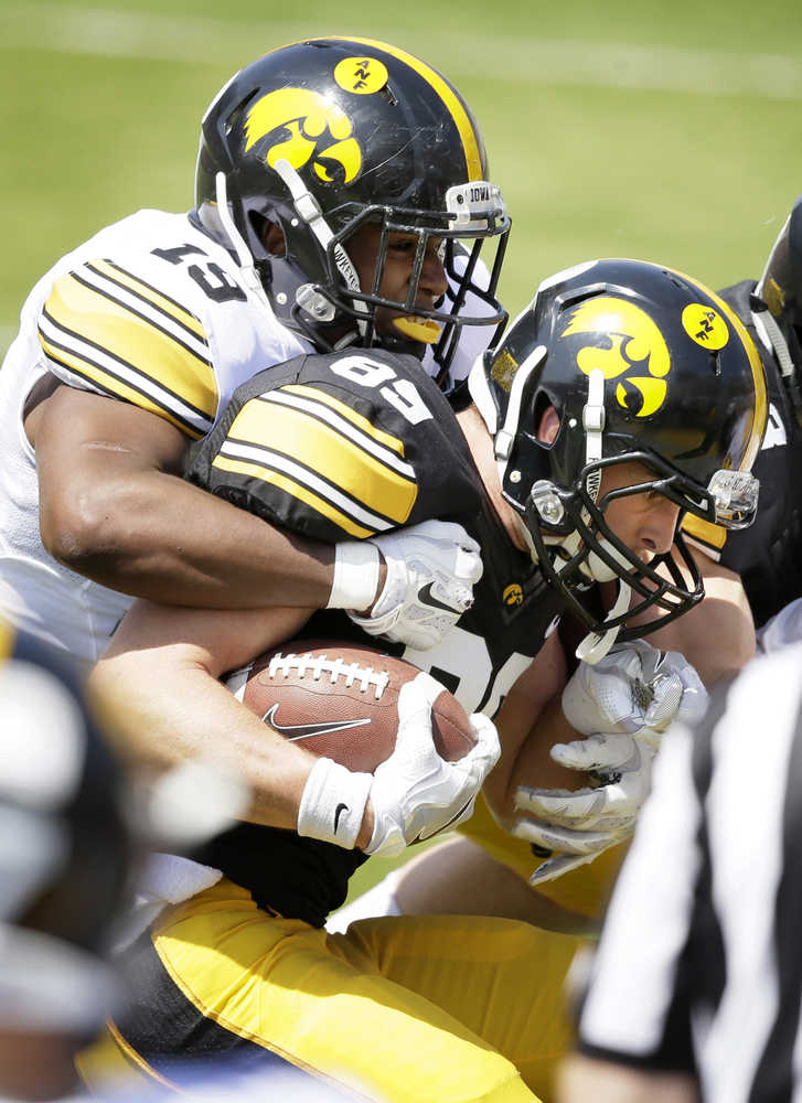 Iowa wide receiver Matt VandeBerg is tackled by defensive back Miles Taylor, left, after making a reception during the team's NCAA college football spring game, Saturday, April 23, 2016, in Iowa City, Iowa. (AP Photo/Charlie Neibergall)