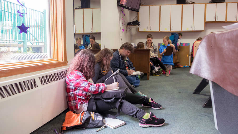 Paul Caldwell, 48, and his daughters Brianna, 13, and Olivia, 12, attend a drawing hangout at the Zach Gordon Youth Center on Saturday during Alaska Robotics' Mini-Con.