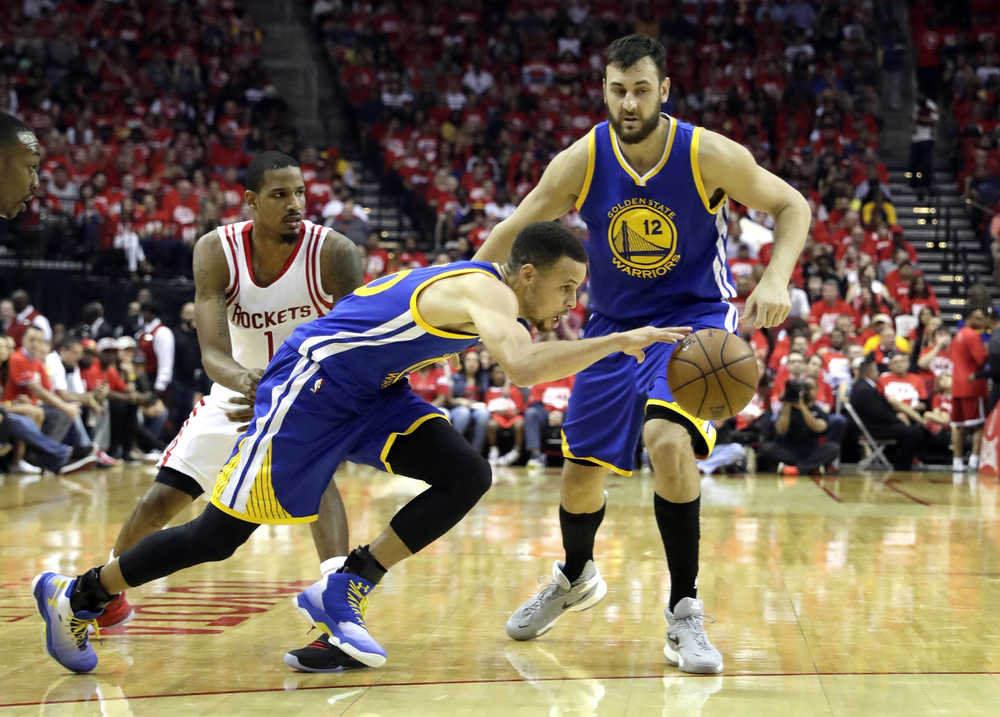 Golden State Warriors' Stephen Curry, center, dribbles past teammate Andrew Bogut, right and Houston Rockets' Trevor Ariza, left, during the first half in Game 4 of a first-round NBA basketball playoff series, Sunday, April 24, 2016, in Houston. (AP Photo/David J. Phillip)