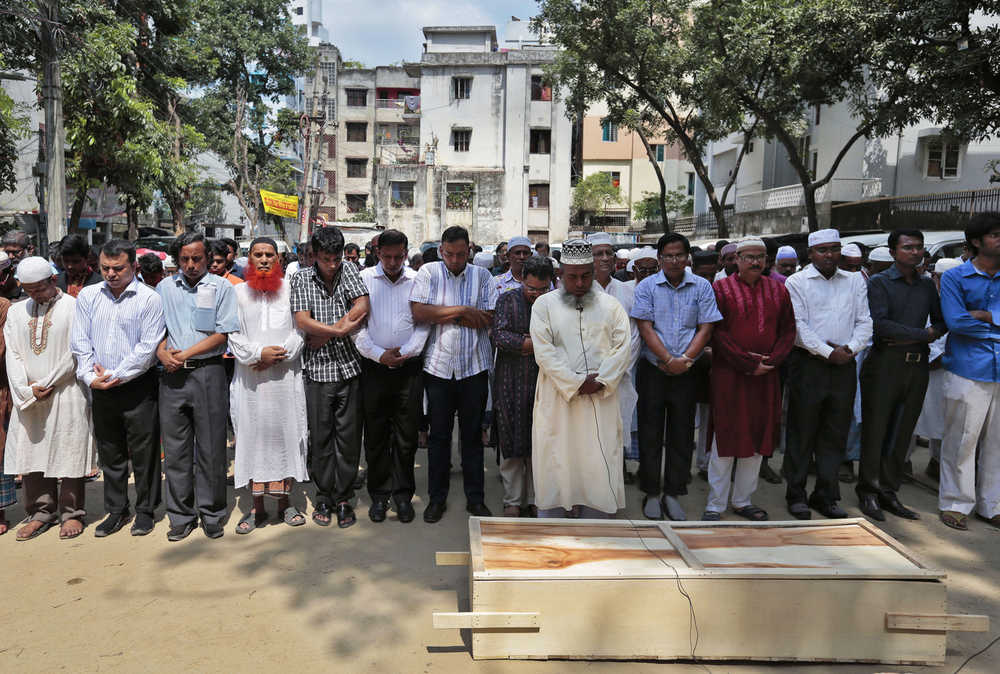 In this Tuesday photo, Bangladeshi Muslims attend the funeral of Xulhaz Mannan who was stabbed to death by unidentified assailants in Dhaka, Bangladesh.