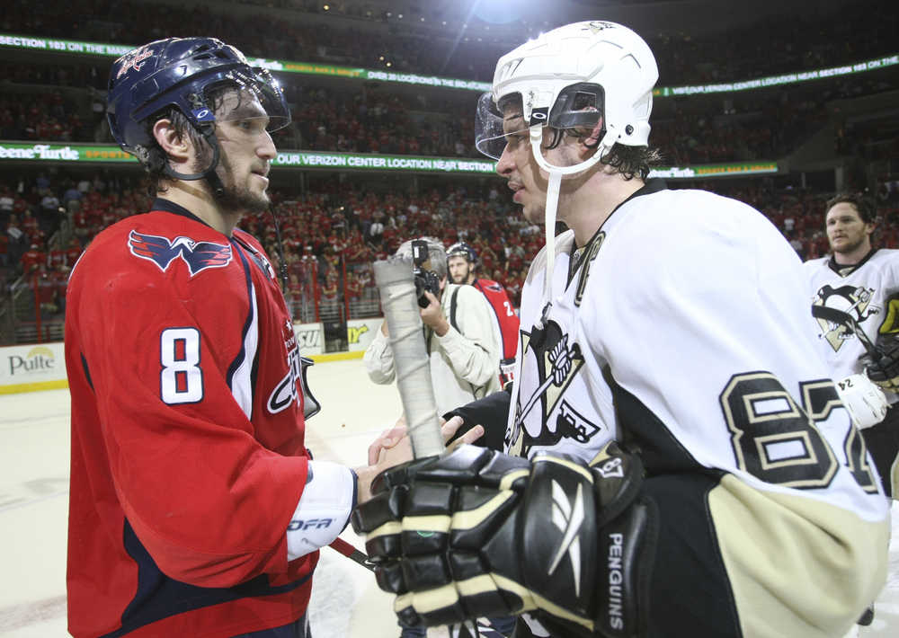 FILE - In this March 13, 2009 file photo, Washington Capitals' Alex Ovechkin (8), from Russia, shakes hands with Pittsburgh Penguins' Sidney Crosby (87) following Game 7 of an NHL hockey second-round playoff series, in Washington. After dispatching the New York Rangers in five games, Pittsburgh faces top-seed Washington in the second round, their ninth postseason clash but the first since 2009. (AP Photo/Bruce Bennett, Pool, File)