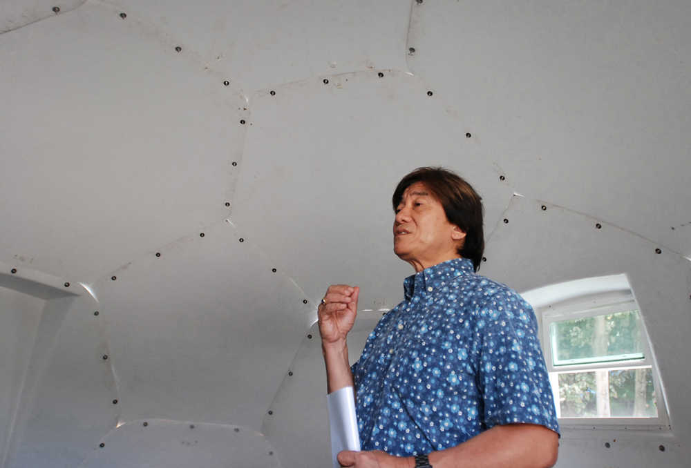 In this Friday, April 22, 2016 photo, Daniel Kaneshiro, a pastor at First Assembly of God church, talks to The Associated Press inside a dome-shaped shelter at the church in Honolulu. The church is looking into an unexpected solution to state's homeless crisis: they're planning to erect Alaska-made igloos to house homeless families. The snow-inspired dome-shape structures would appear at first glance to be a misfit among the island state's palm trees and sandy beaches, but their bright fiberglass exterior reflects the sun, shading those inside. (AP Photo/Caleb Jones)