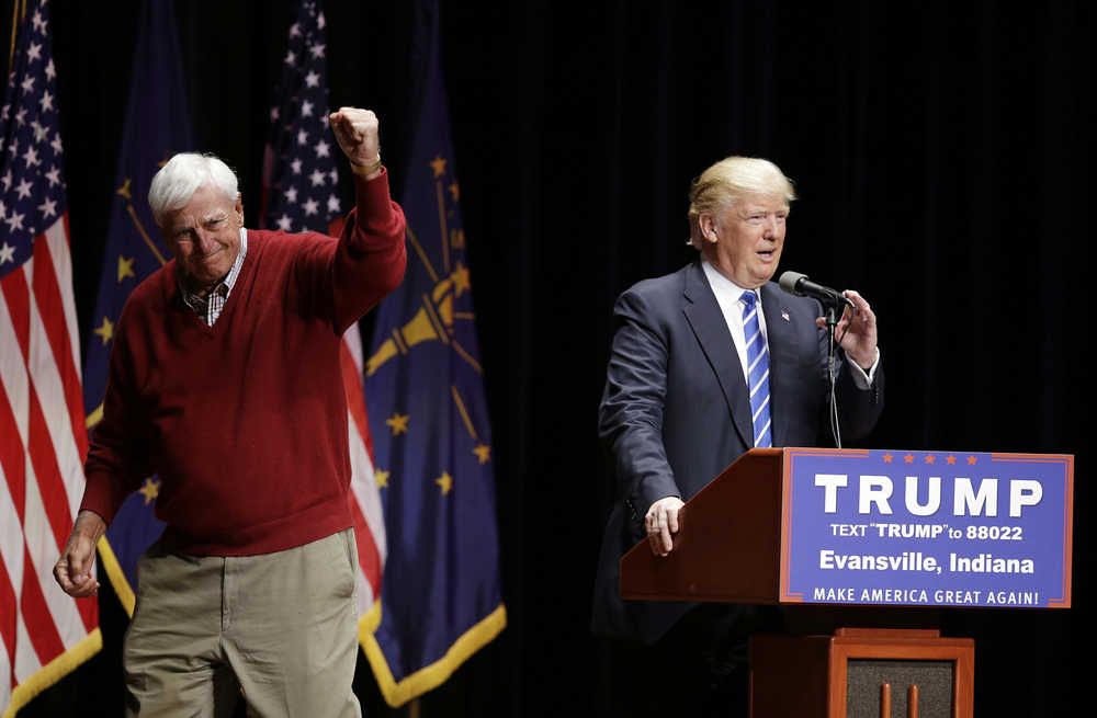 Former Indiana basketball coach Bob Knight raises his fist after talking about Republican presidential candidate Donald Trump during a campaign stop at Old National Events Plaza, Thursday, April 28, 2016, in Evansville, Ind. (AP Photo/Darron Cummings)
