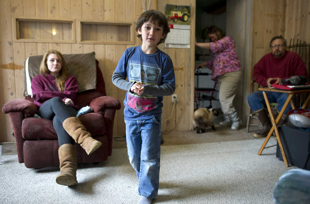Miles Curtis, right, and his wife, Tonya, with their daughter, Angelica, left, and her son, Jonathan Torres, at their rented home in Haines in early April. The Curtis are trying to regain legal custody of Jonathan, conceived by statutory rape when Angelica was 13 in Petersburg.